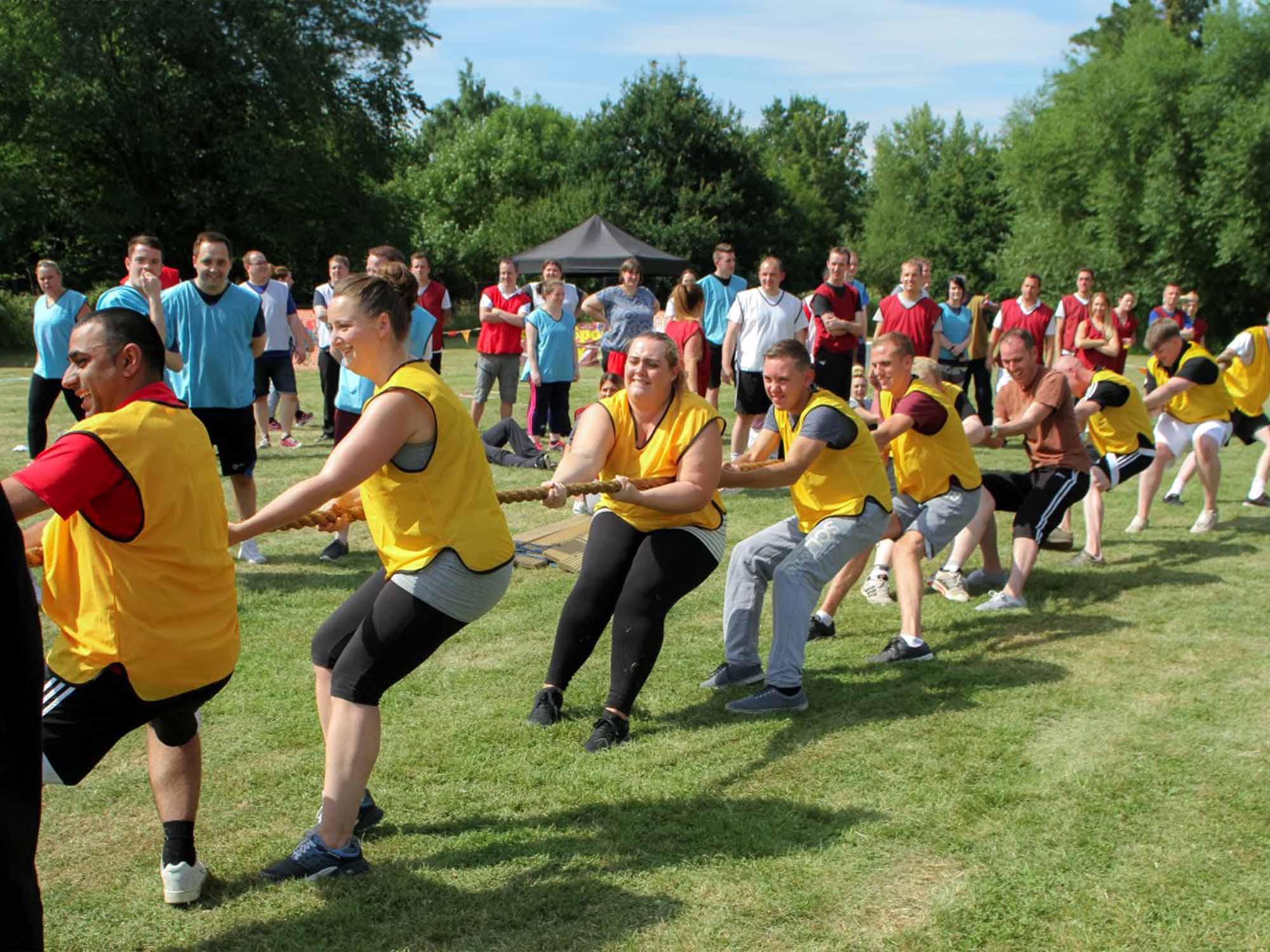 Large group taking part in outdoor Battle of Olympus team challenge in Manchester
