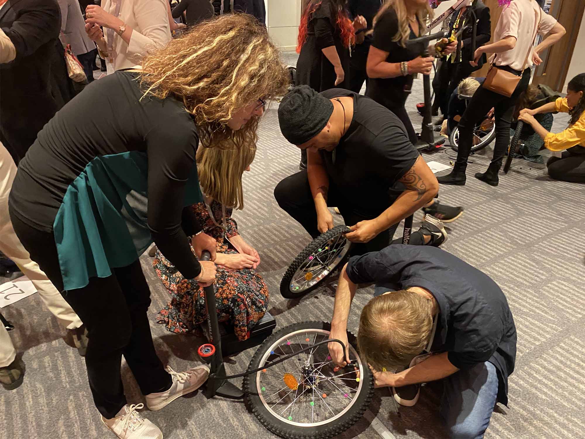 Teams building bikes for charity at a Manchester corporate event