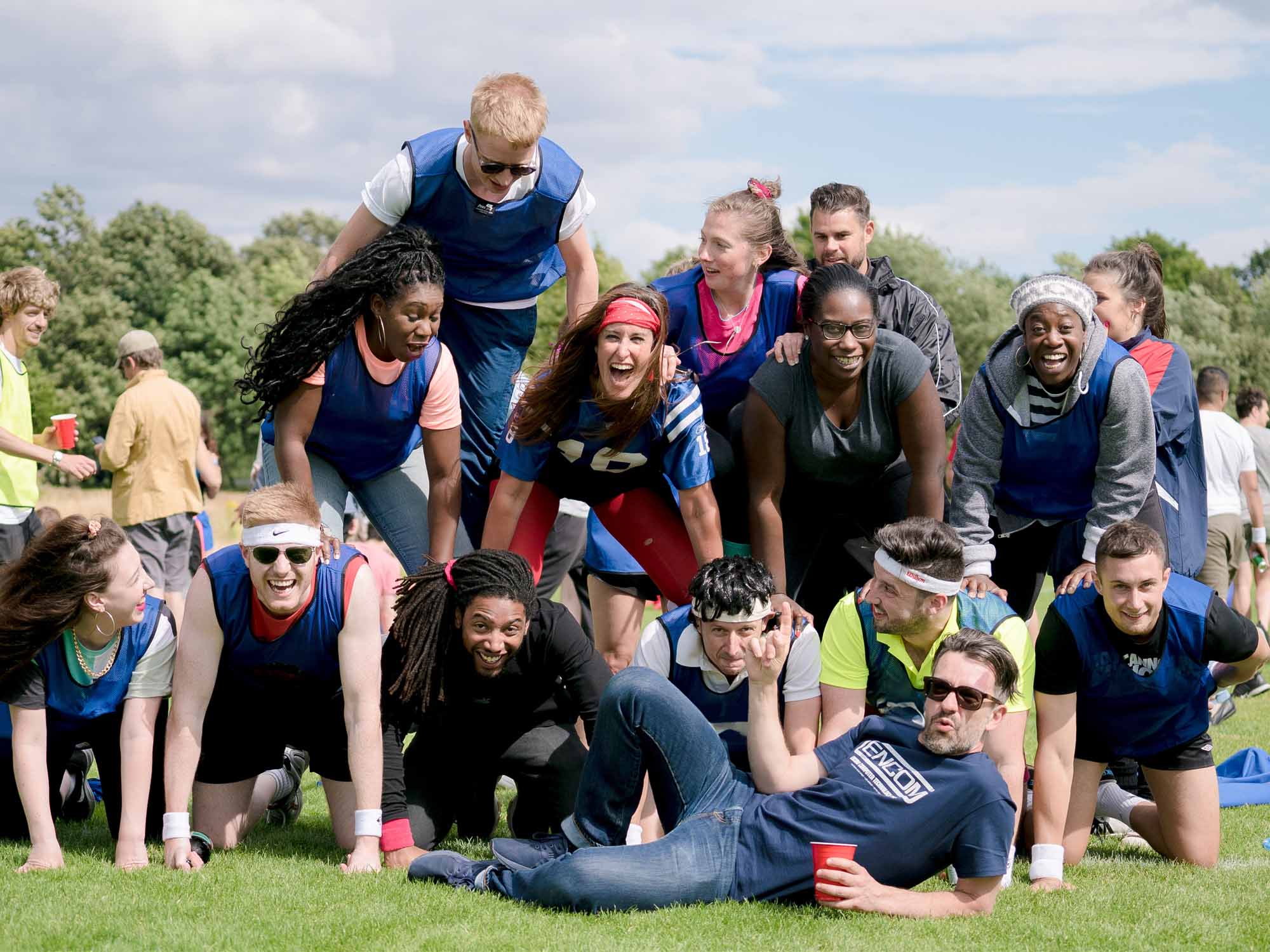 Colleagues competing in sack race at corporate sports day in Manchester park