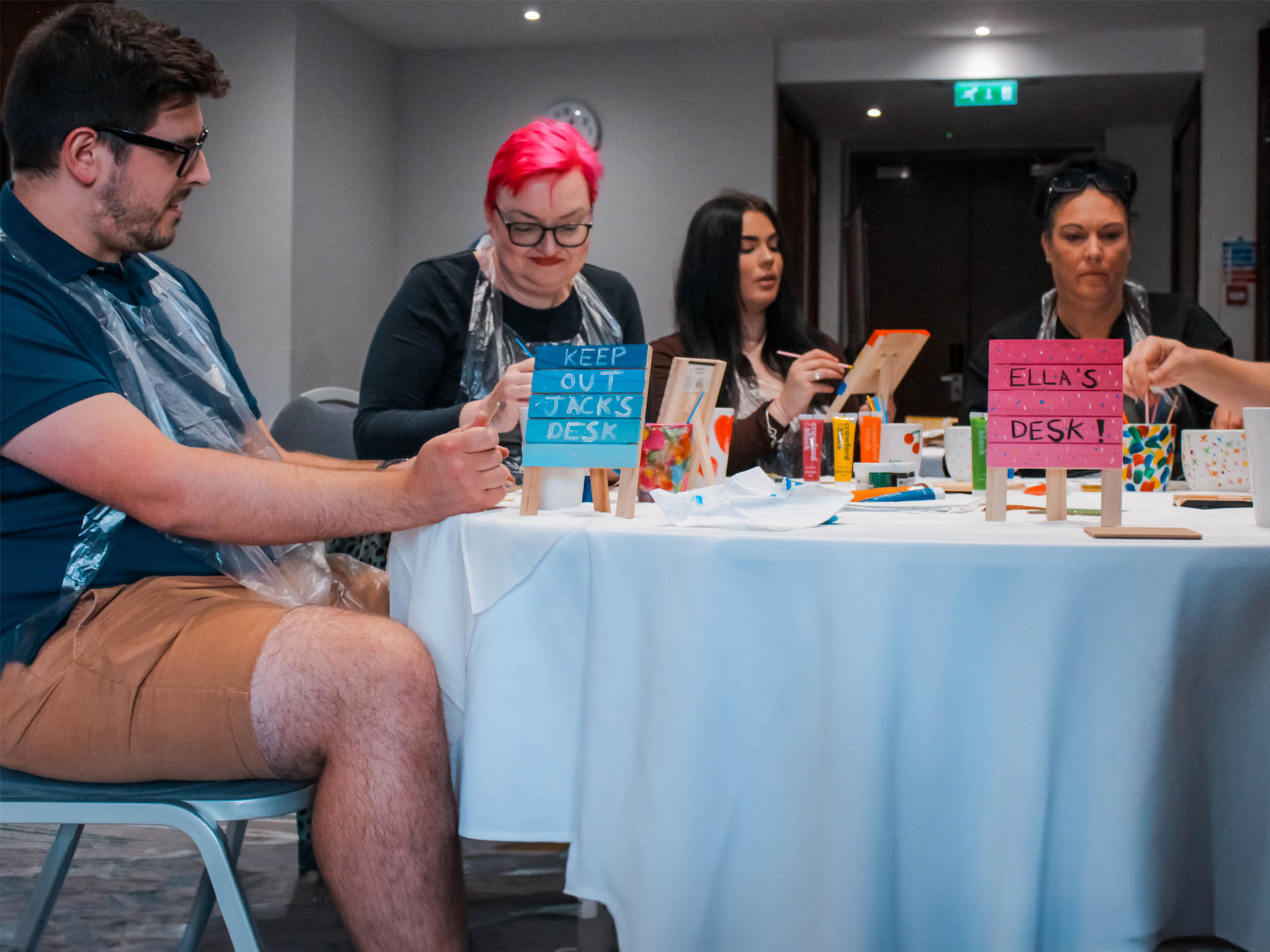 Cocktail making class for team building in Manchester bar Team customising coasters and mugs in a desk accessory painting class in Manchester