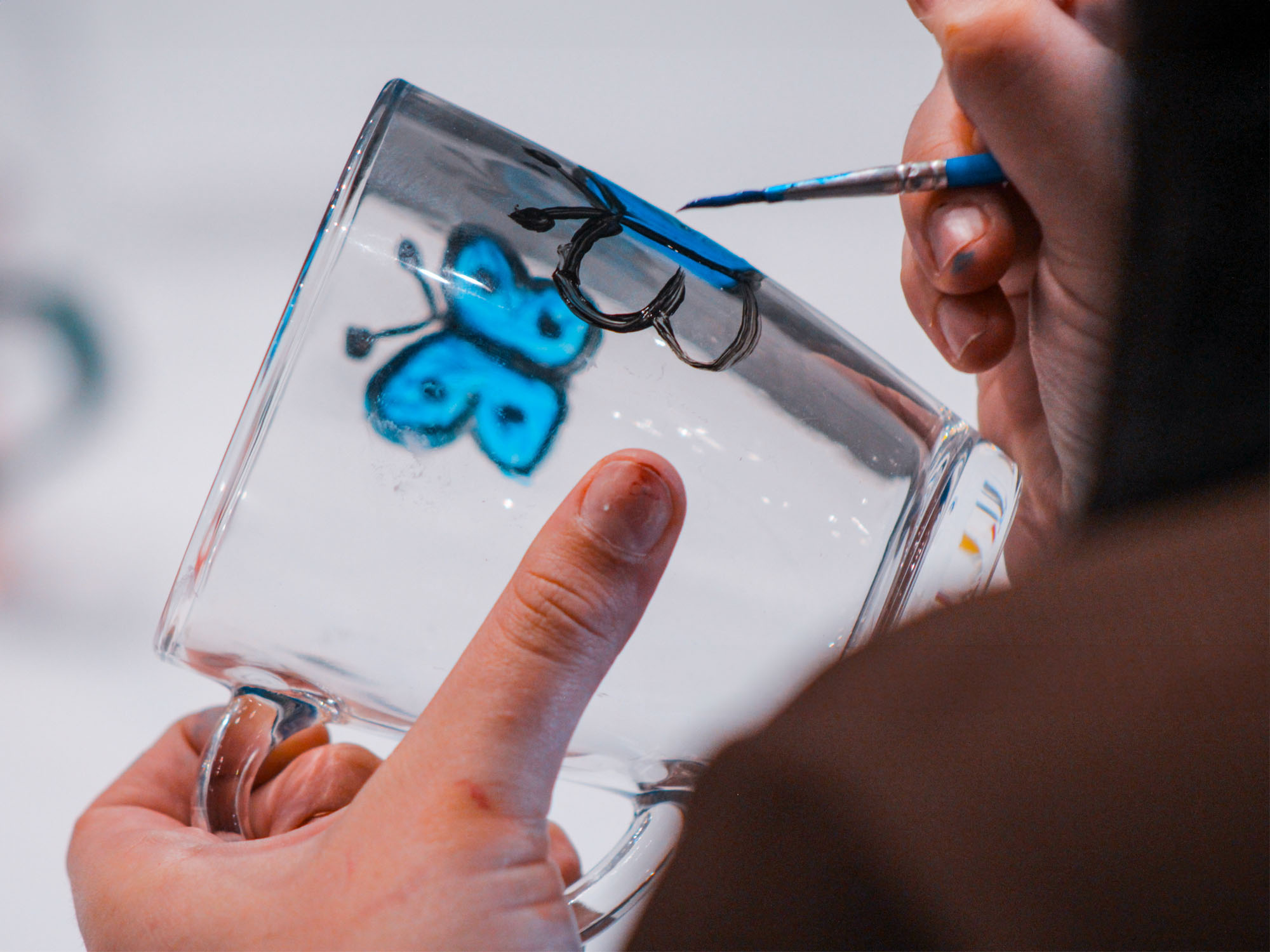 Participants painting glassware at a team building session in Manchester