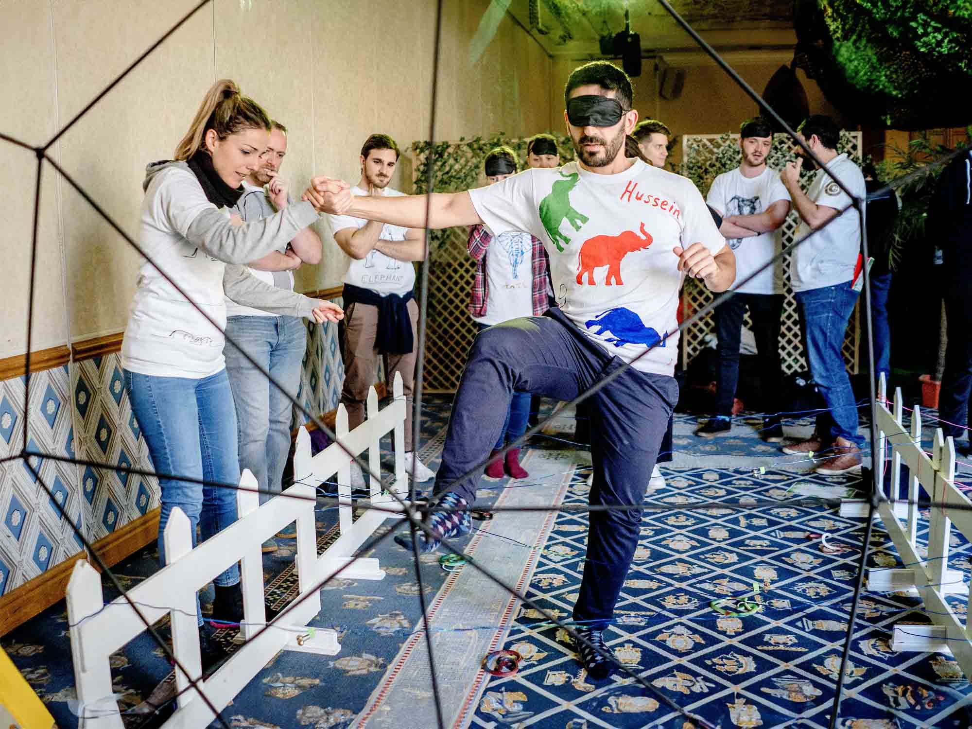 Office team doing jungle-style team trials indoors in Manchester venue