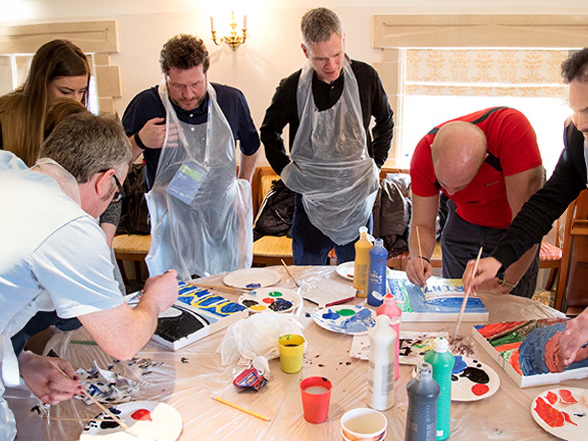 Team painting masterpiece indoors in a Manchester venue