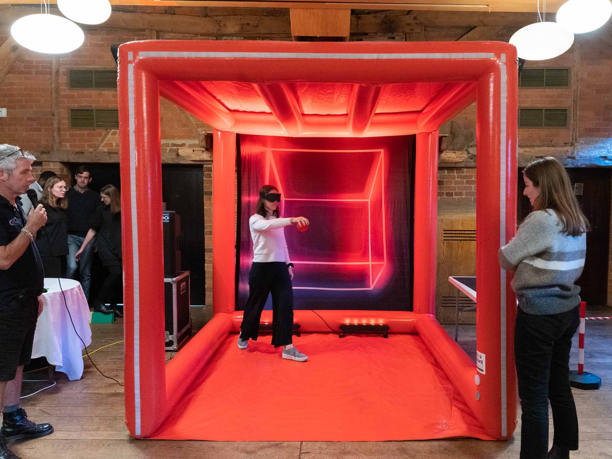 Team members facing cube-style challenges at indoor venue in Manchester