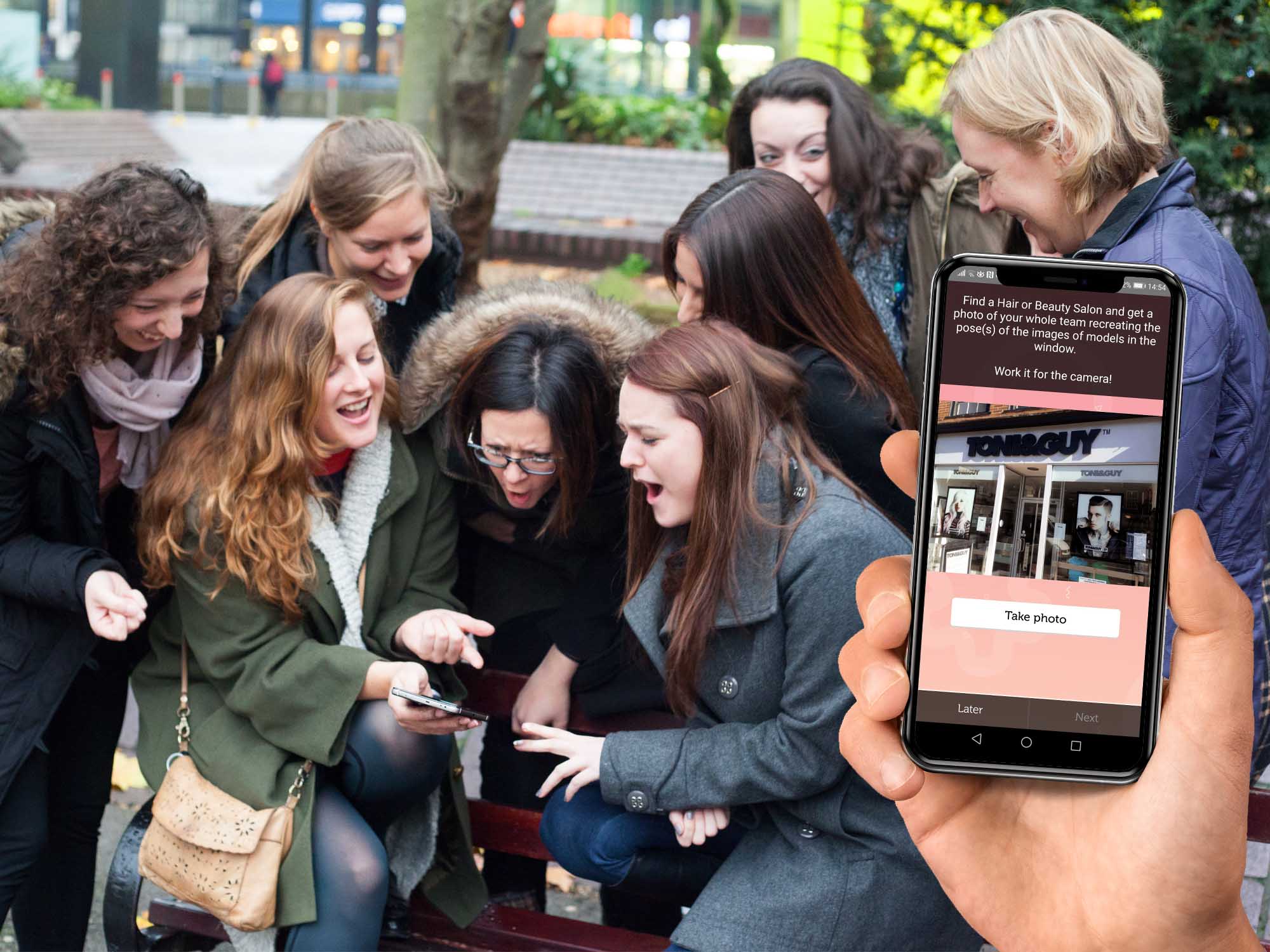 Team exploring Deansgate during a smartphone treasure hunt in Manchester